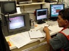 Scientist monitoring video screen for towed camera