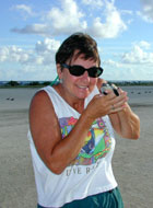 Ann Bell, US FWS Educator with baby green sea turtle.